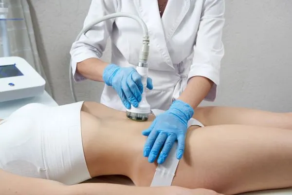Lost the Weight but Not the Loose Skin? 2 woman having HIFU treatment on her stomach to combat loose skin Wiltshire following weight loss